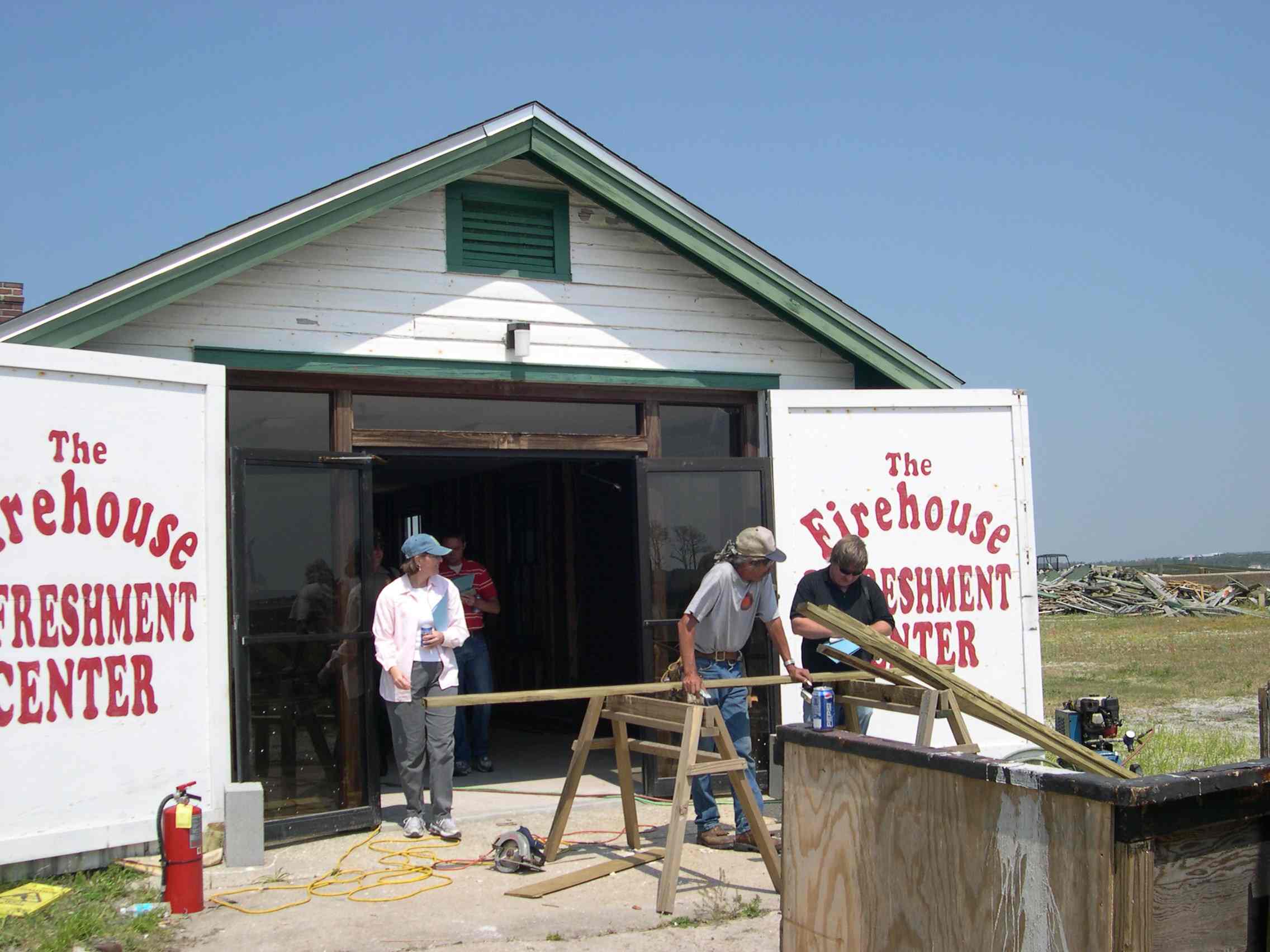 the press interviews workers repairing the Fire house