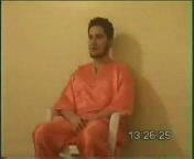 Nick Berg seated on a chair during the first moments of the video.