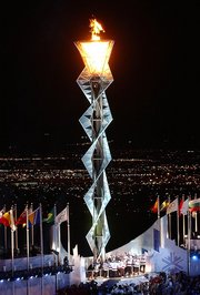 Opening ceremonies climax with the lighting of the Olympic Flame.  For lighting the torch, modern games feature elaborate mechanisms such as this cauldron-spiral-cauldron arrangement lit by the  at the .
