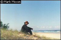 Mark sitting on a beach